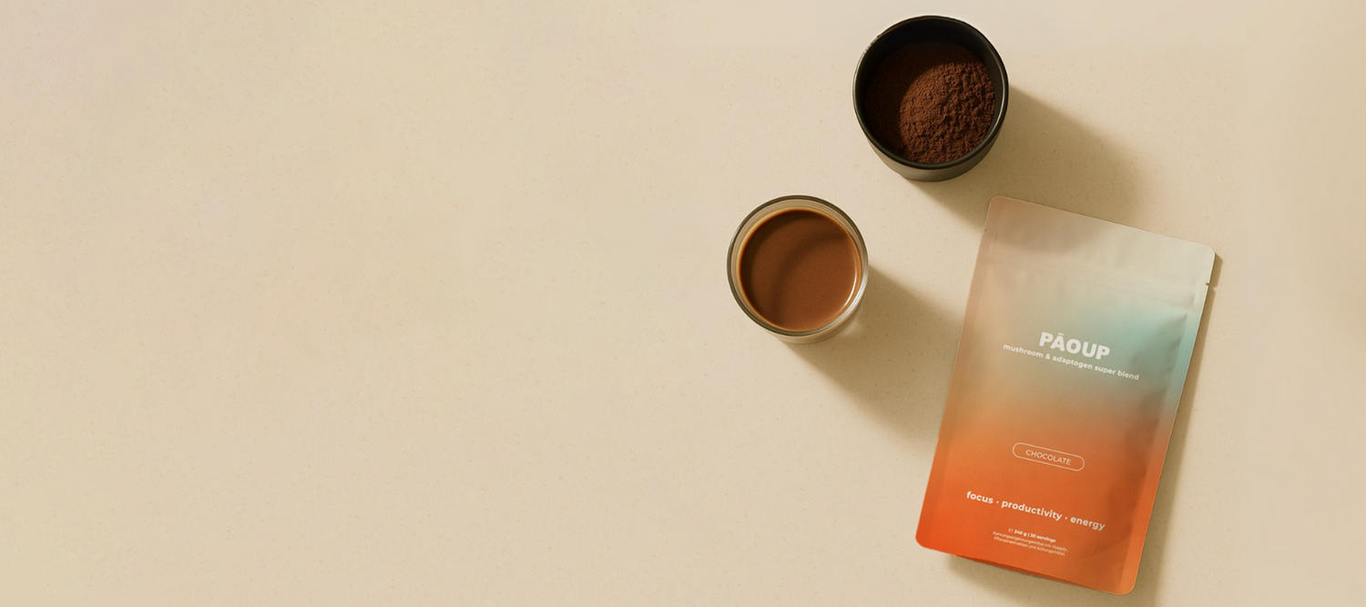 Two small containers of cacao and a gradient packaging pouch of PAOUP Cacao on a beige background