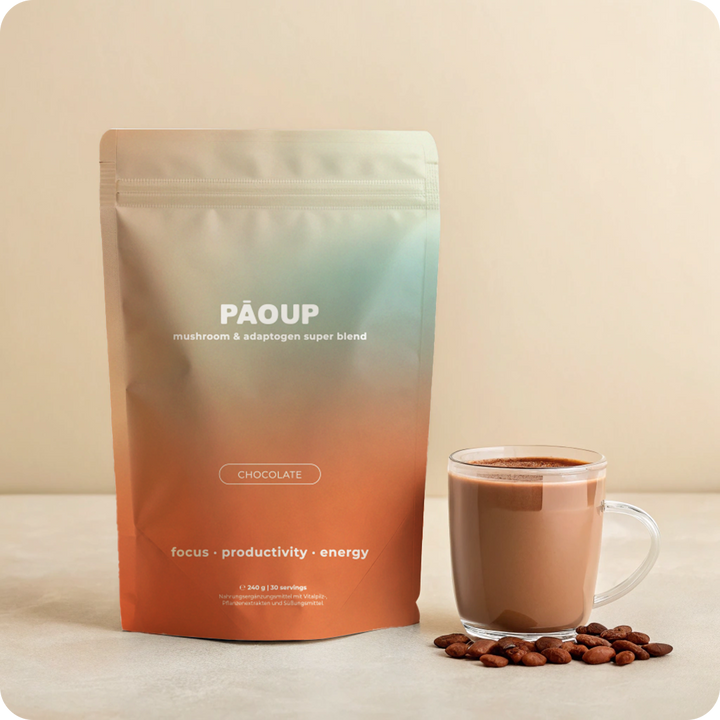 PAOUP chocolate super blend package with a cup of coffee and beans on a beige background